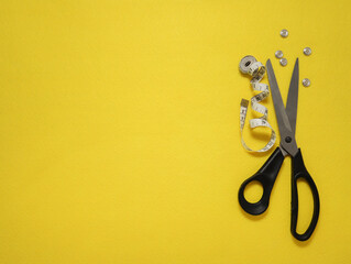 Tailor scissors on yellow felt background