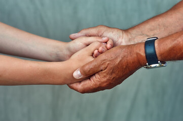 Hands of the son and father close-up . Family concept of care and love