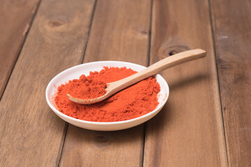 Chili poder over wooden background,high angle shot.