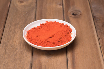 Chili poder over wooden background,high angle shot.