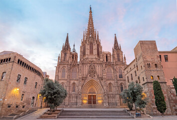 Fototapeta na wymiar Barcelona - The facade of old gothic cathedral of the Holy Cross and Saint Eulalia at dusk.