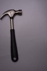 A hammer over grey surface