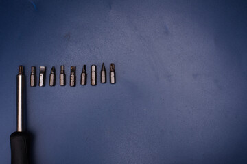 Fototapeta premium Screwdriver bits on a blue background