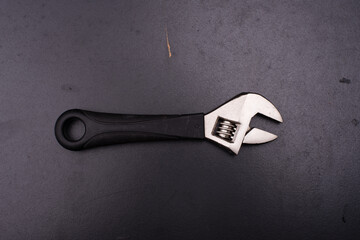 adjustable wrench  over dark surface