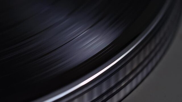 Extreme close up of a vinyl record turntable coming to a stop