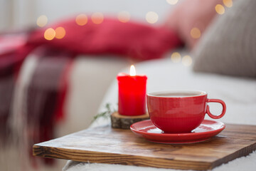 cup of tea with burning candles at home