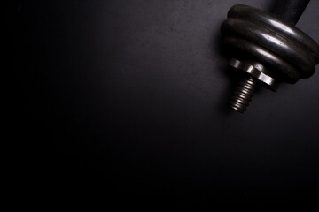 An iron dumb bell isolated over dark background