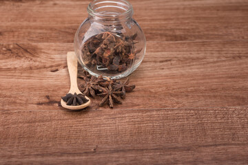 Star anise isolated over wooden background