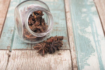 Star anise isolated over wooden background