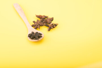 Star anise isolated over yellow background
