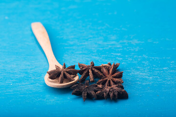 Star anise isolated over blue wooden background