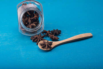 Star anise isolated over blue wooden background