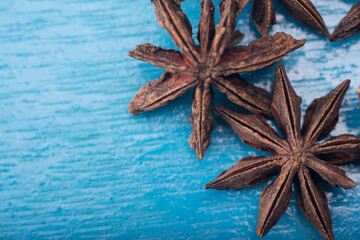 Star anise isolated over blue wooden background
