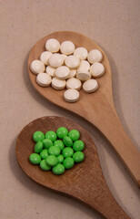 Pills and colored capsules out of the package. Color tablets and capsules from the wing view.