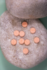 Some pills and white capsules. Pills and capsules together outside the package in the container.