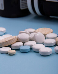 Pills and colored capsules out of the package. Color tablets and capsules from the wing view.