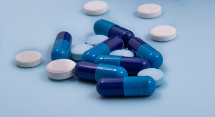 Pills and colored capsules out of the package. Color tablets and capsules from the wing view.