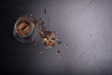 Herbs and spice isolated over dark wooden background