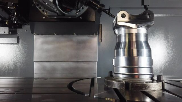 Precision milling CNC machine tool makes part.