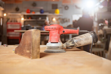 Male carpenter working on old wood in a retro vintage workshop.