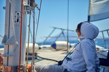 Summertime cruising enjoying on a sailing boat at open sea.