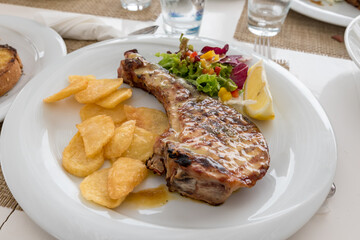 Chop with salad potatoes and lemon