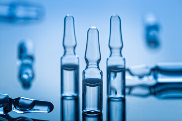 Groupe of medical glass ampules on blue background