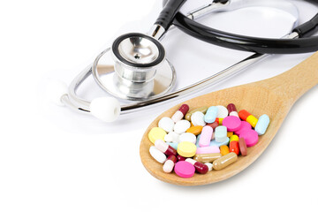 stethoscope and pills on white background
