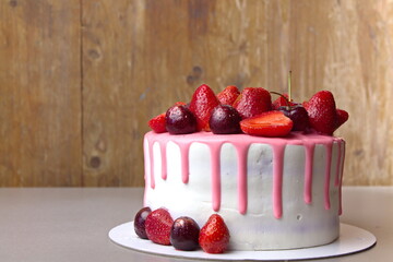 Diet cake with berry fillings, multi-colored striped with rice flour decorated with ripe...