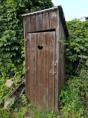 Old wooden outdoor toilet in nature