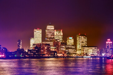 Fototapeta premium London at night and river Thames. High buildings with luminous windows.