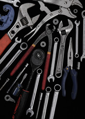 Industrial tools such as French wrenches and a variety of wrenches from a close-up in the form of color and black and white images.