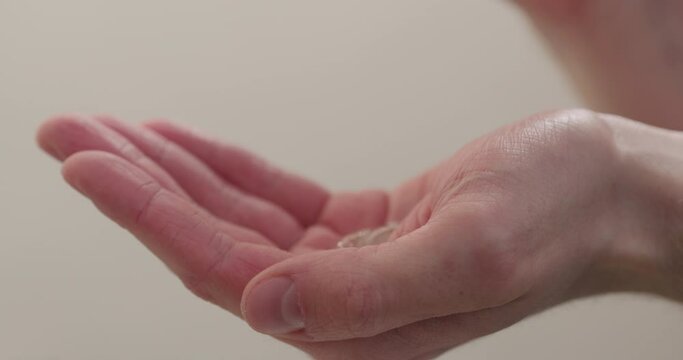 Slow motion man hands apply sanitizer gel on hands