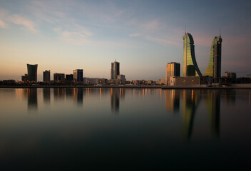 Fototapeta na wymiar The Bahrain skyline with beautiful hue in the sky, a view from Bahrain bay