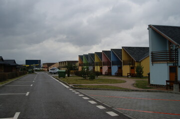 Fototapeta na wymiar colorful holiday homes on the background of clouds