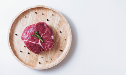 Raw meat, beef steak, on wooden board, on white background