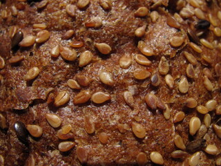 Close-up of a golden brown crust of bread with grains