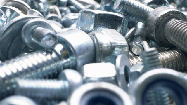 super close. nut and bolt parts, fasteners in a heap