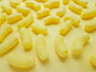 Yellow corn sticks on a yellow background.
