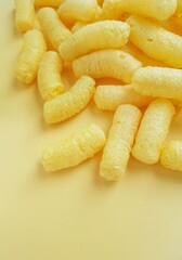 Yellow corn sticks on a yellow background.