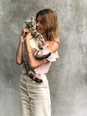 The girl is holding a cat.