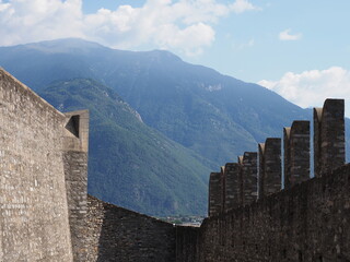 Medieval wall of castel grande in european Bellinzona city, capital of canton Ticino in Switzerland, clear blue sky in 2017 warm sunny summer day on July.