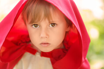 Close-up portrait of a girl in a fabulous costume of Little Red Riding Hood