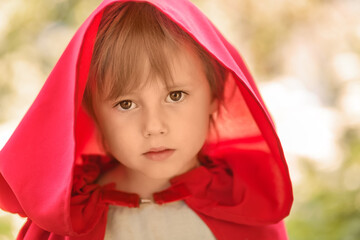 Close-up portrait of a girl in a fabulous costume of Little Red Riding Hood