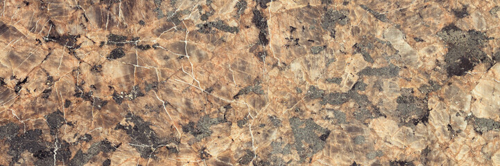 The texture of the rock. Natural stone background. Brown mineral with black spots. Wide panoramic texture for background and design.