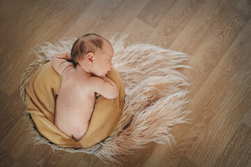 newborn baby wrapped in a blanket sleeping in a basket. concept of childhood, healthcare, IVF. Black and white photo