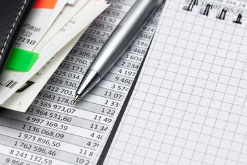 business office desk closeup - financial reports, analysis and accounting, set of documents, tables and graphs, various items for bookkeeping, calculator