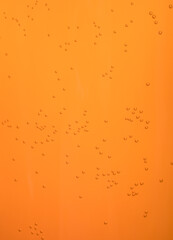 Small bubbles in orange juice. Background pattern.