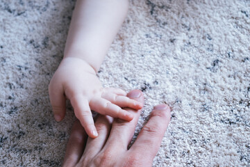 Baby hand on her daddy hand.