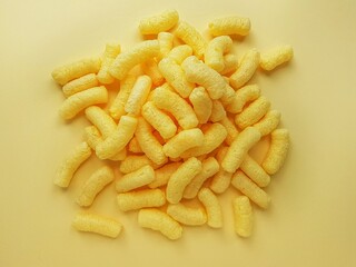 Yellow corn sticks on a yellow background.